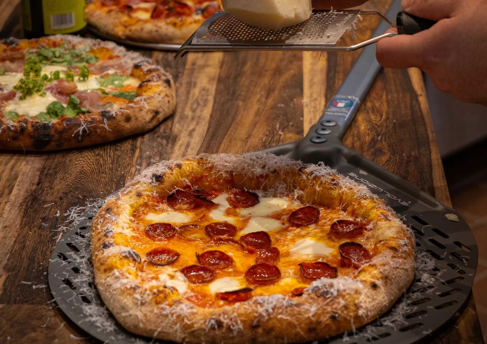 A Bravado pizza topped with greens